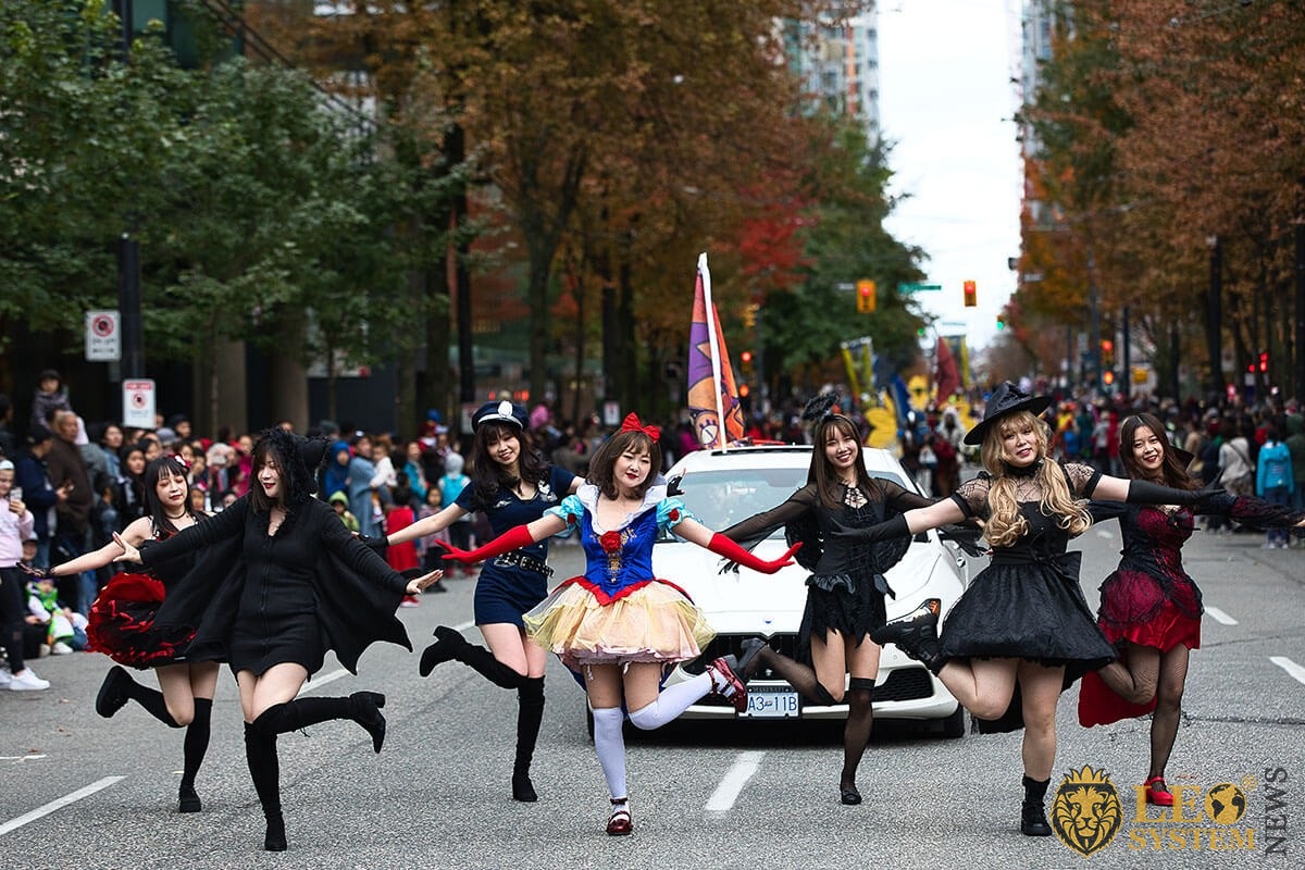 Vancouver's Halloween street parade - girls dance in carnival costumes