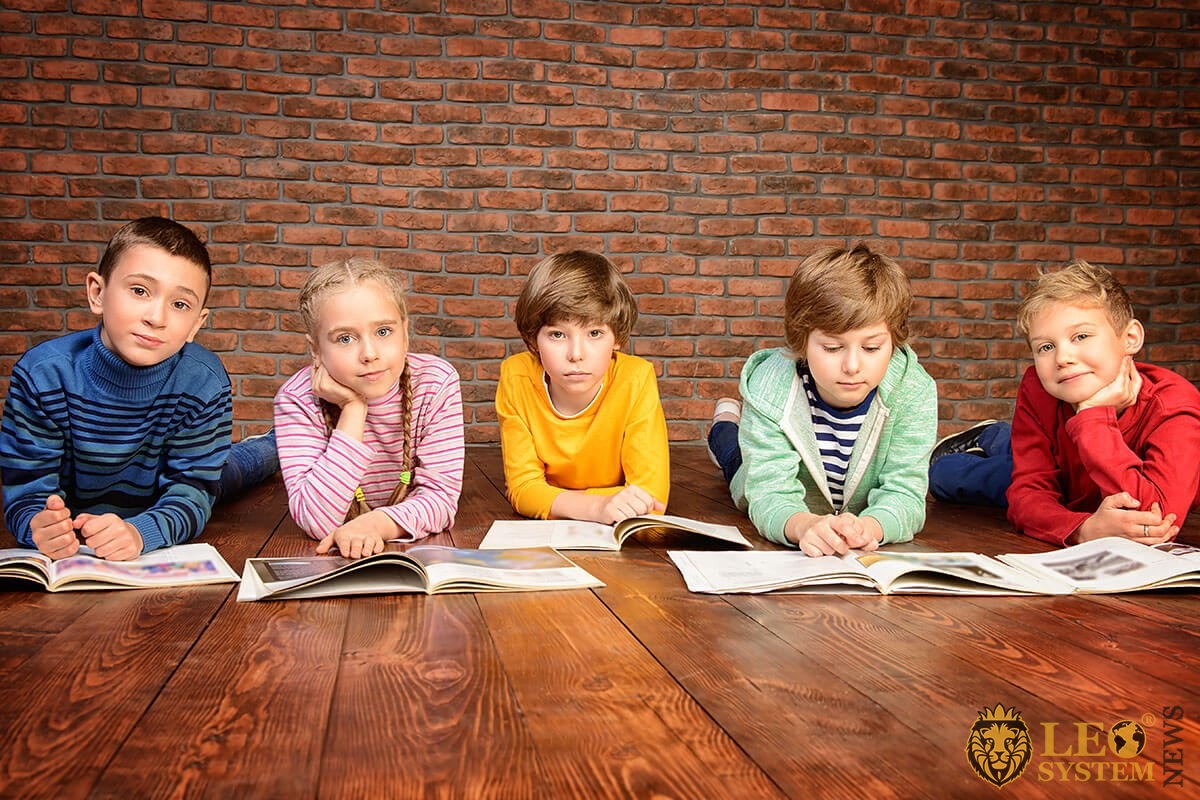 Child psychology - several children read magazines and perceive reading differently