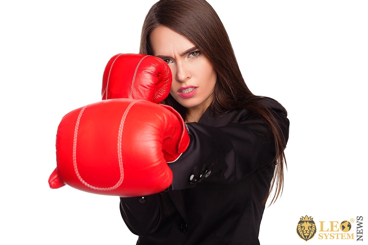 Business woman in boxing glove