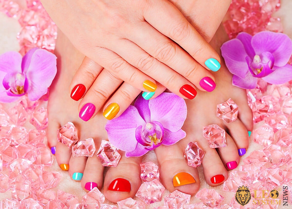 Multicolored pedicure and flowers