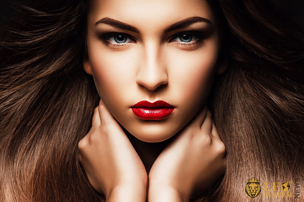Image of a woman with bright red lipstick and beautiful eyebrows