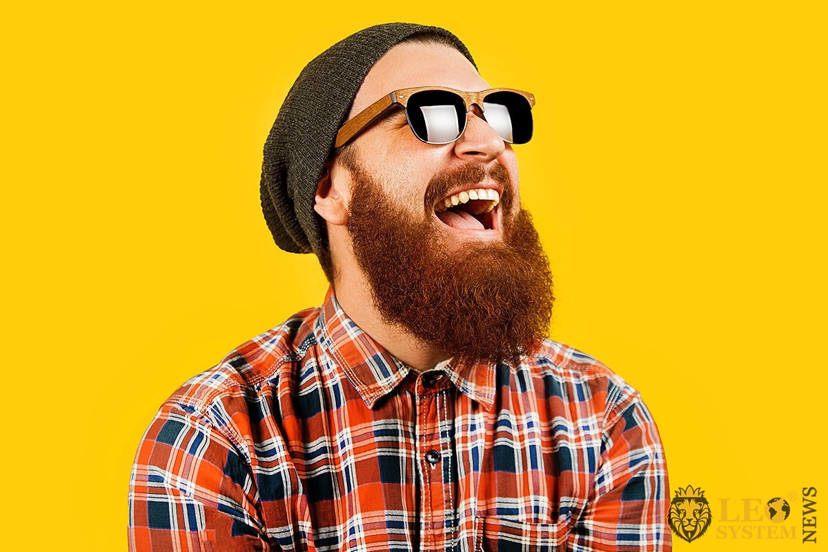 Image of a greedy man with a big beard and glasses