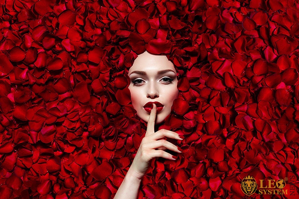 Image of a female face around rose petals