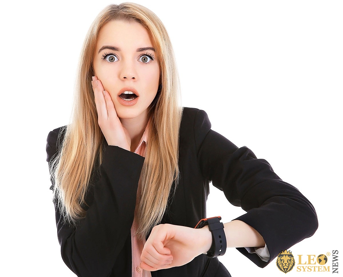 Image of a surprised girl who is looking at her watch