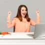 Image of joyful woman at work table in office