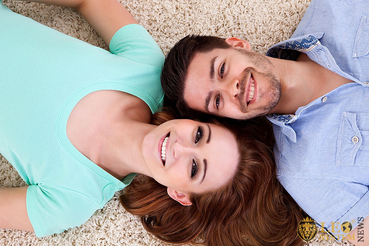 Image of a couple lying on a carpet