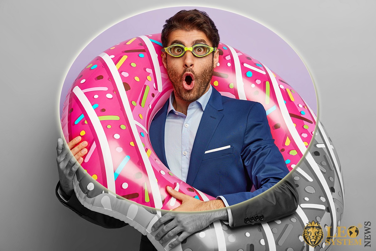 Image of a cheerful man with an inflatable ring