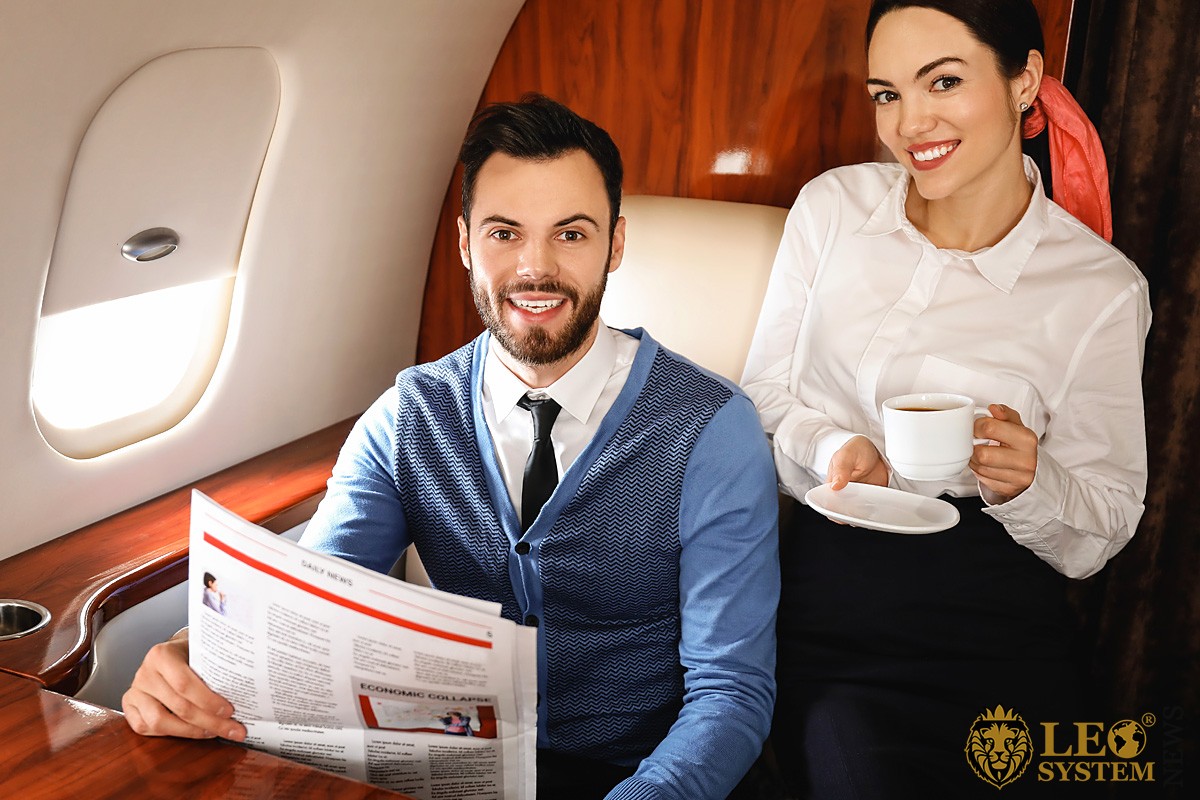 Image of a business couple on board an airplane