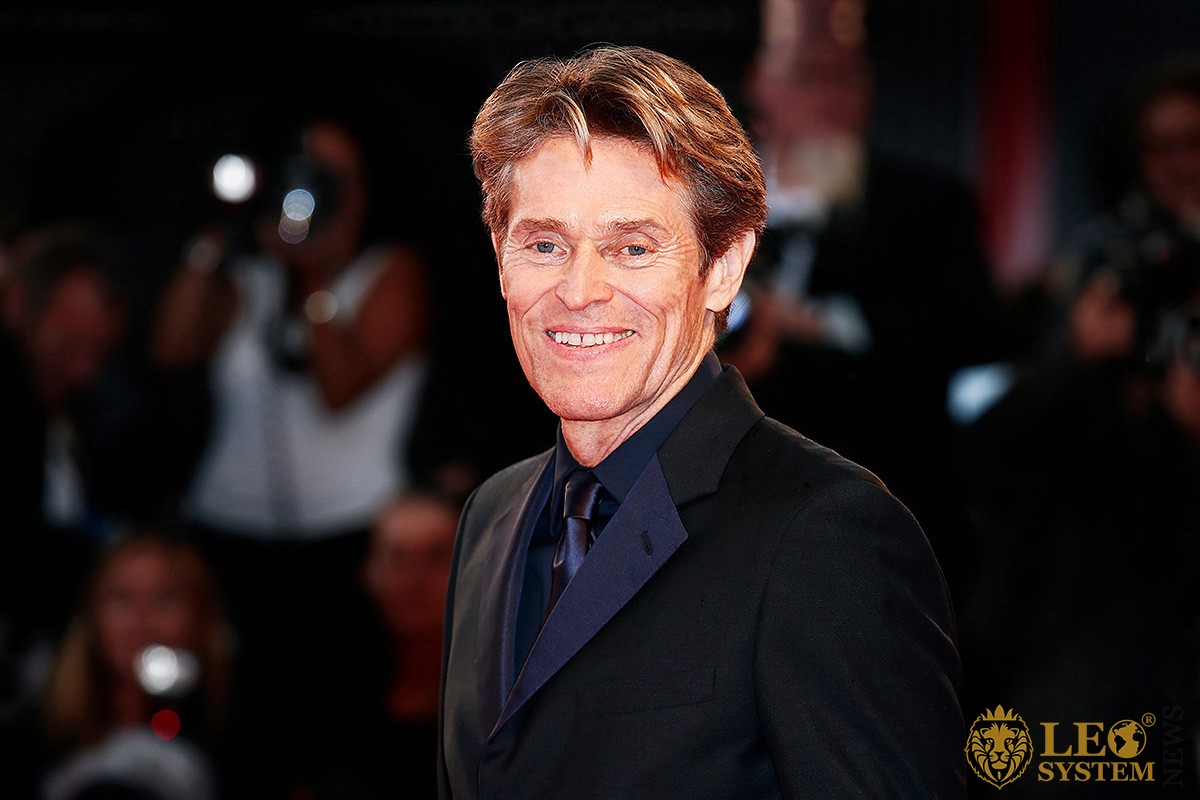 Image of American actor Willem Dafoe in a beautiful suit