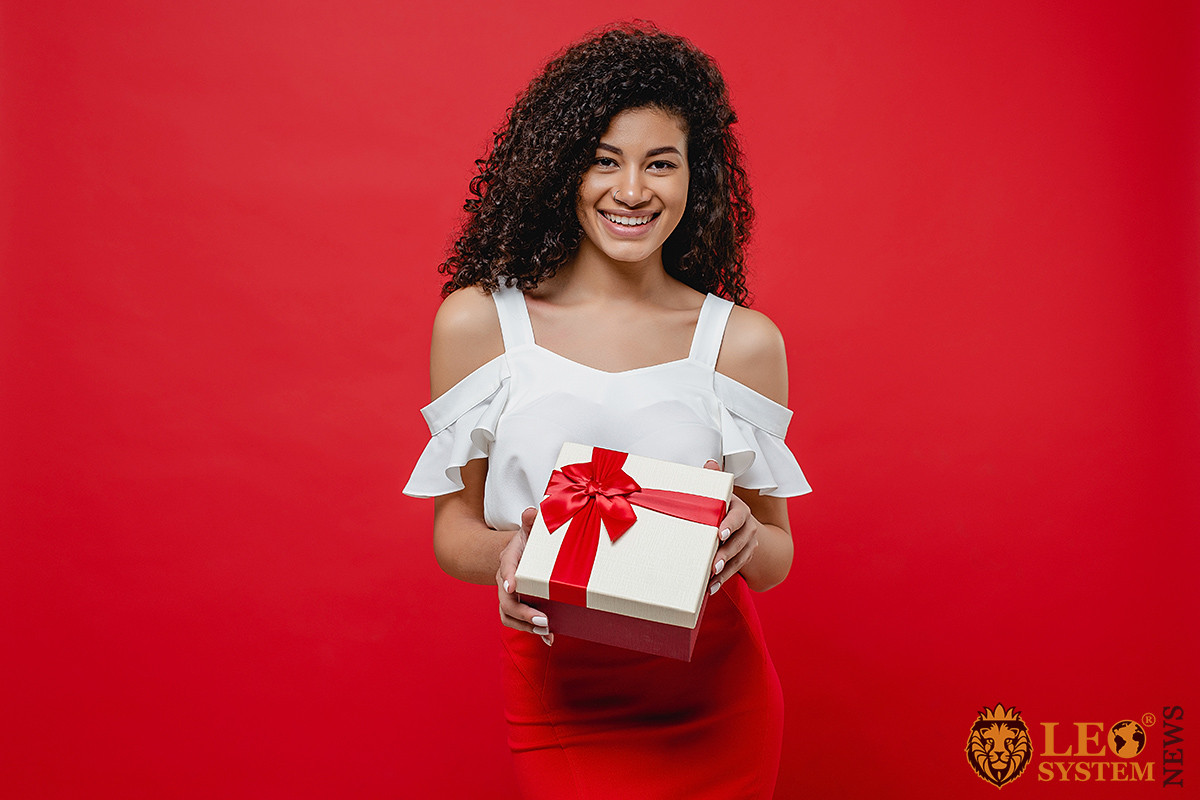 Cute girl with a big gift in her hands