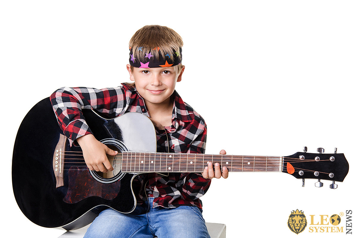 Boy playing the big guitar