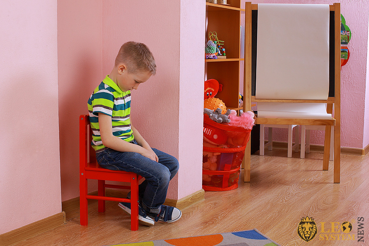 Image of withdrawn and upset boy sitting on chair